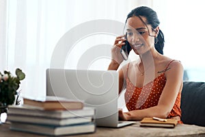 Let me have a look for you. an attractive young businesswoman sitting in her office and using her laptop while on a