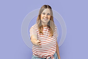 Let me introduce myself. Woman giving hand to handshake, greeting guests with toothy smile.