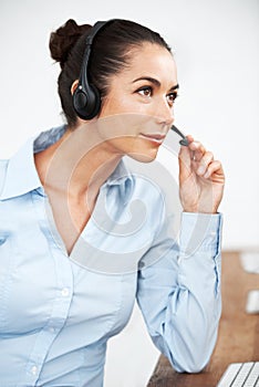 Let me see if I can help...Attractive female customer service agent using a headset for client services.