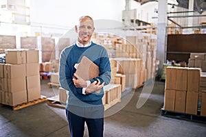 Let me take the guesswork out of logistics. Portrait of a mature man standing on the floor of a warehouse.