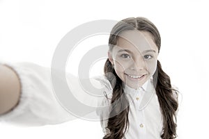 Let me take a selfie. Child girl school uniform clothes holds smartphone takes photo. Child school uniform kid happy