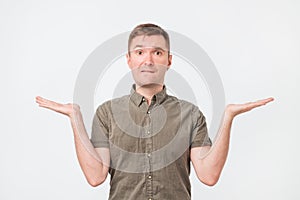 Let me think and select concept. Doubtful pensive man with thoughtful expression making choice.