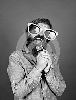 Let music flow in your heart. performer having fun. mature bearded man in funny party glasses sing song. brutal male