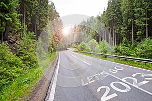 Let`s Go 2023 written on the road in the forest