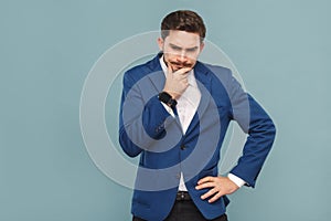 Let`s me think. Pondering young adult man touching chin