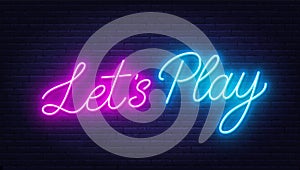 Let s Play neon sign on brick wall background.