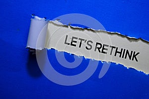 Let`s Rethink Text written in torn paper