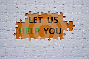 Let us help you symbol. White puzzle with words Let us help you. Beautiful orange background. Business and Let us help you concept