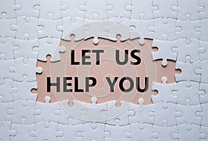 Let us help you symbol. White puzzle with words Let us help you. Beautiful pink background. Business and Let us help you concept.