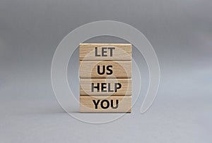 Let us help you symbol. Wooden blocks with words ILet us help you. Beautiful grey background. Business and Let us help you concept