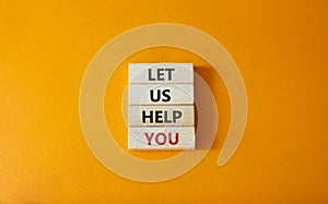 Let us help you symbol. Wooden blocks with words Let us help you. Beautiful orange background. Business and Let us help you