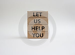 Let us help you symbol. Wooden blocks with words Let us help you. Beautiful white background. Business and Let us help you concept