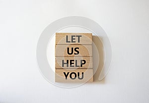 Let us help you symbol. Wooden blocks with words Let us help you. Beautiful white background. Business and Let us help you concept