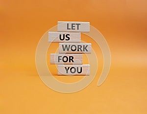 Let us work for you symbol. Wooden blocks with words Let us work for you. Beautiful orange background. Business and Let us work