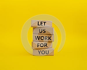 Let us work for you symbol. Wooden blocks with words Let us work for you. Beautiful yellow background. Business and Let us work