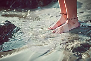 Let the water touch your toes and reach your soul. Cropped shot of an unrecognizable woman at the beach.