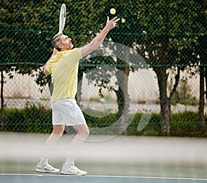 Lets begin. Full length shot of a handsome mature male tennis player serving during his match.