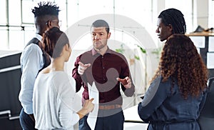 Lets each put our best efforts into this. a group of businesspeople having a discussion in an office.