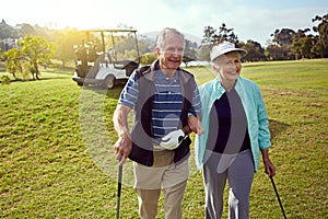 Lets get going. a smiling senior couple enjoying a day on the golf course.