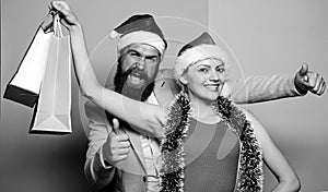 Lets get party. santa man and woman with tinsel. christmas shopping sales. winter holidays celebrate together. happy new
