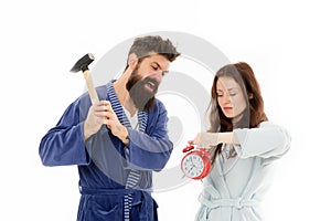 Lets get rid of this annoying alarm clock. Couple in bathrobes going to destroy alarm clock and stay at home. Breaking