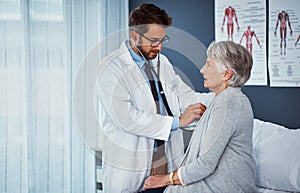 Lets hear what the heart is saying. a doctor examining a senior patient with a stethoscope in a clinic.
