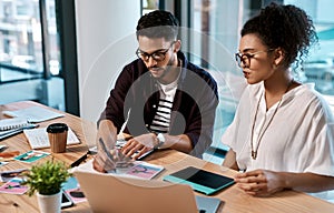 Lets mark this one so we dont forget. Cropped shot of two young businesspeople sitting together and having a meeting