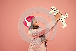 Lets play together. pink is her favorite color. small kid listen music headphones. child long curly hair. cosy winter