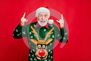 Lets rock-and-roll. Portrait of funky grey hair modern old man wear santa claus cap show horns fool on x-mas heavy metal