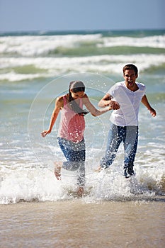 Lets runaway and start a life of our own. a young couple being playful on the beach.