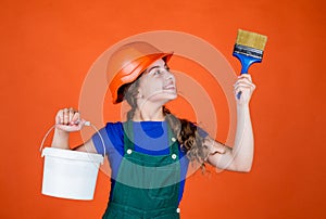 Lets start. childhood and people concept. teen kid ready for painting. girl in protective helmet with paint brush. Child
