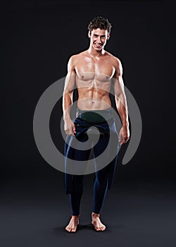 Lets tear up the water. Studio shot of a muscular young swimmer.