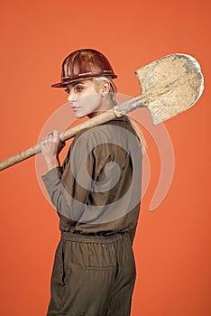 lets work. labor day. woman in boilersuit and helmet. female builder hold shovel.