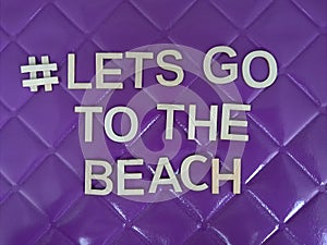 #letsgotothebeach lets go to the beach message on a purple background