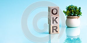 Letter of the alphabet of OKR on a light blu background. okr - objectives and key results