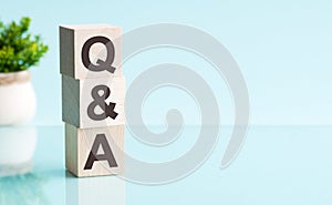 Letter of the alphabet of Q and A on a light blu background