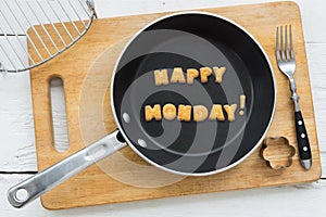 Letter biscuits word HAPPY MONDAY and cooking equipments. photo