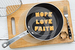 Letter biscuits word HOPE LOVE FAITH and cooking equipments.