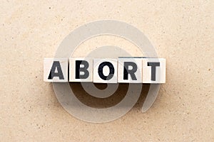 Letter block in word abort on wood background