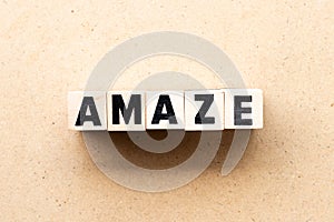 Letter block in word amaze on wood background