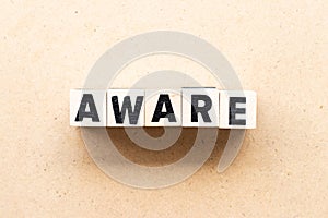 Letter block in word aware on wood background