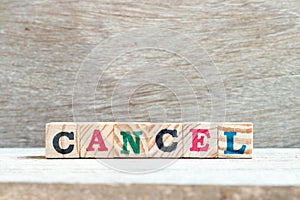 Letter block in word cancel on wood background