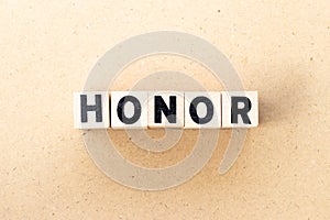 Letter block in word honor on wood background