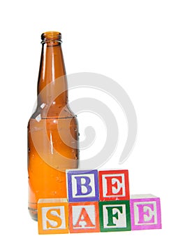 Letter blocks spelling be safe with a beer bottle