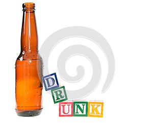 Letter blocks spelling drunk with a beer bottle