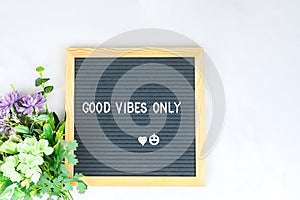 Letter board with phrase Good vibes only white background, flowers with heart. Concept of mental health. Aspiration, supportive