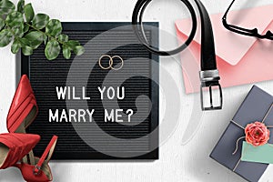 Letter board with proposal text `will you marry me?`