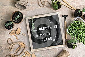 Letter board with text Garden is my happy place. Planting seeds in Biodegradable paper eco-friendly seed pots. Garden shovel and