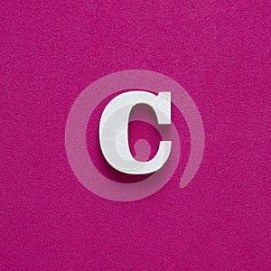 Letter C uppercase - White wood font on rhodamine red background