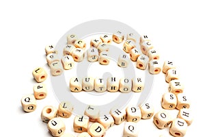 letter cubes lying on white table. Building word: Author